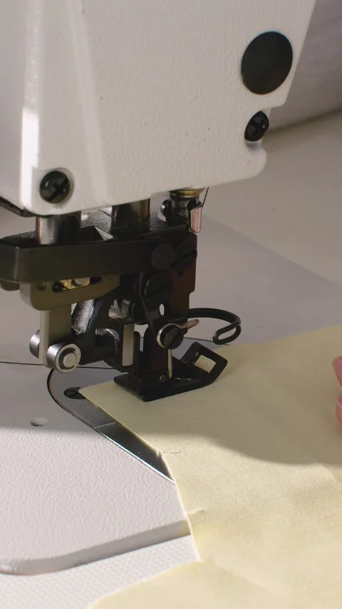 Industrial sewing machine head stitches cream fabric Stock Footage 326478490