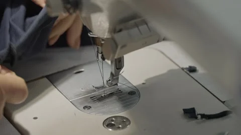 Industrial sewing machine stitching fabric edge Stock Footage 331982803