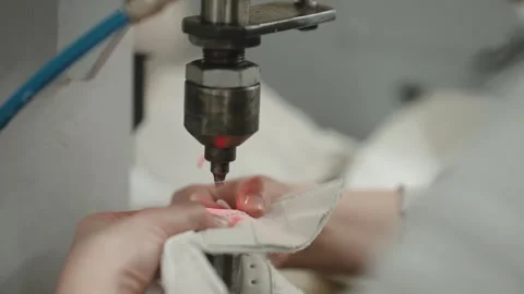 Industrial sewing machine stitching white leather material closeup Stock Footage 333015997