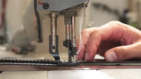 Industrial sewing machine stitching a zipper in a garment factory Stock Footage 338189279