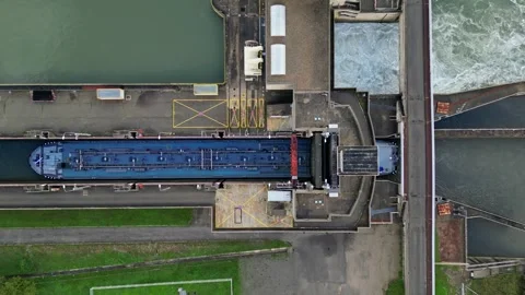 Industrial ship passing through the lock above the hydroelectric power plant. Stock Footage 290840473