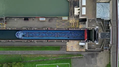 Industrial ship passing through the lock above the hydroelectric power plant. Stock Footage 290840515