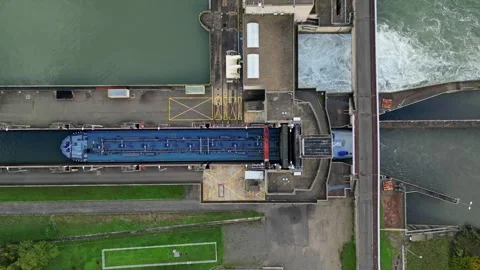 Industrial ship passing through the lock above the hydroelectric power plant. Stock Footage 290840692
