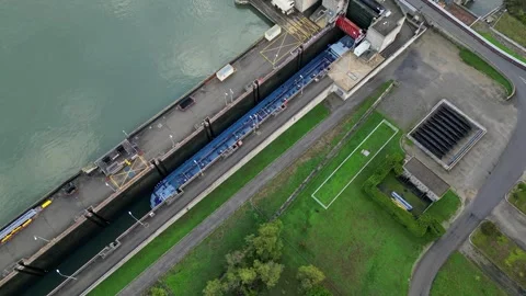 Industrial ship passing through the lock above the hydroelectric power plant. Stock Footage 290840840
