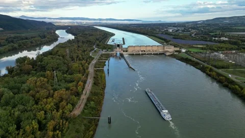 Industrial ship passing through the power plant on the Rhone river Stock Footage 289843266