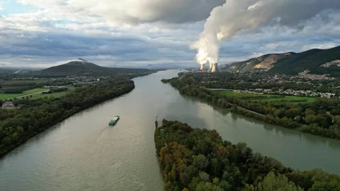 An industrial ship sails down the Rhone River in the morning with steam rising Stock Footage 290816206