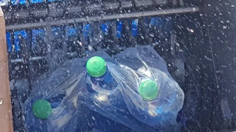 Industrial Shredder Machine Crushing Plastic Bottles for Recycling Close Up Stock Footage 335838917