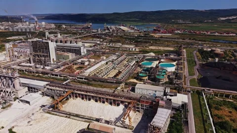 Industrial site along the river with large structures and storage areas Stock Footage 341328599
