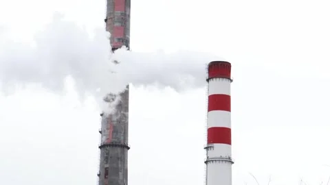 Industrial smokestacks release clouds over a gray sky 스톡 동영상 295346483