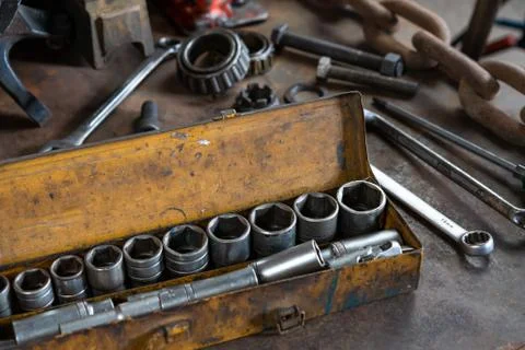 Industrial socket set inside a yellow toolbox on a work bench - Ratchet socket Stock Photos
