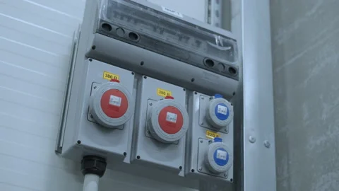 Industrial sockets and plug on distribution board. Factory site electricity Stock Footage 257812944