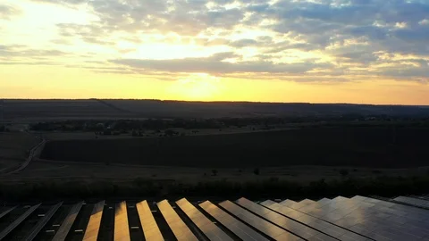 Industrial solar plant at sunset. Video of solar panels from a drone. Stock Footage