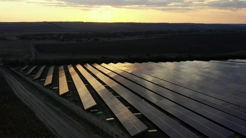Industrial solar plant at sunset. Video of solar panels from a drone. Stock Footage