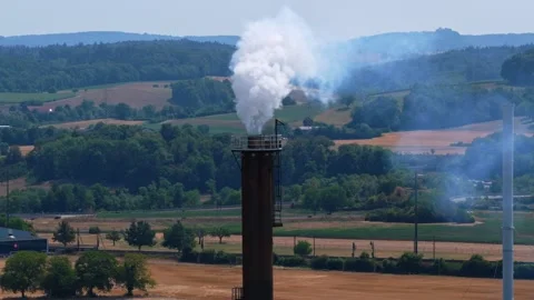Industrial Steam Stack in Swiss Rural Landscape with Smooth Pan 스톡 동영상 340236234