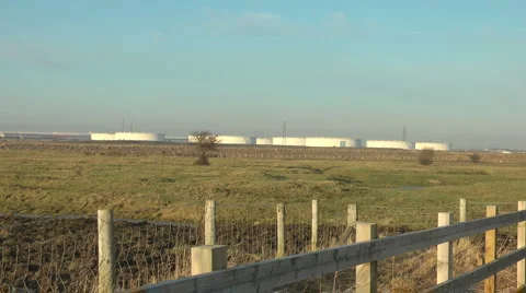 Industrial Storage Tanks across fields Stock Footage 1046813