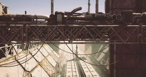 Industrial structures with weathered surfaces in an arid landscape setting Illustrazione stock