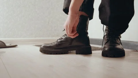 Industrial style work boots on polished wooden surface. Preparation scene Stock Footage 342334971