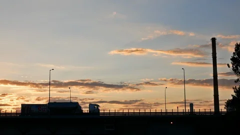Industrial Sunset. Sun Goes Down Behind Power Plant Pipe and Highway with Cars Stock Footage 111972176