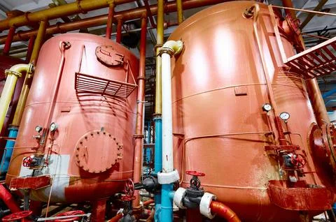 Industrial tanks in a processing facility showcasing large equipment and pipes Stock Photos