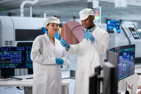Industrial Team Of Diverse Professionals Using SCADA For Chip Manufacturing. Stock Photos