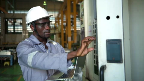 Industrial technician using a laptop computer to monitor machinery systems Video stock 339201896