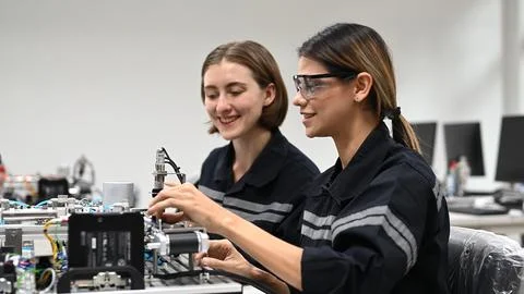 Industrial technicians working with machine maintenance Stock Photos