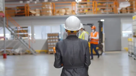 Industrial technologist in formalwear using tablet discussing production plan Stock Footage 143577461