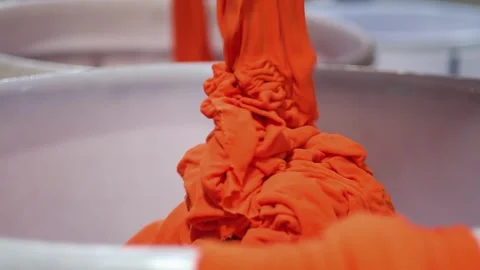 Industrial Textile Dyeing Process with Orange Fabric Stock Footage 329766743