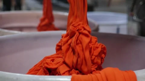 Industrial Textile Dyeing Process with Orange Fabric Stock Footage 329766744