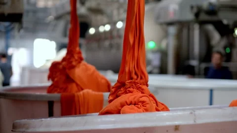 Industrial Textile Dyeing Process with Orange Fabric Stock Footage 330396347