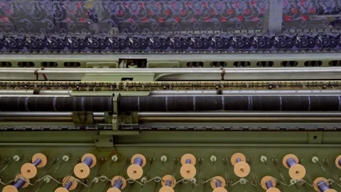 Industrial textile machinery with thread spools producing lace fabrics Stock Footage 332073946
