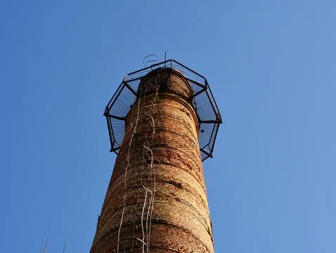 Industrial tower or pipe with observation balcony. Smokestacks with ladder or Stock Photos