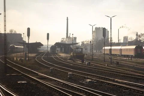 Industrial train station landscape with multiple tracks and passenger trains, Foto stock