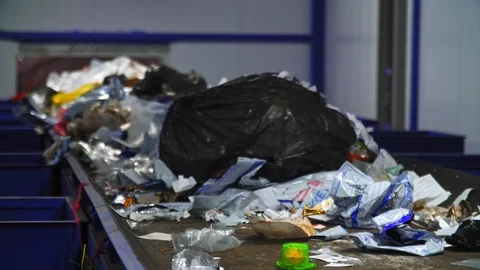Industrial trash conveyor system. Garbage moving on conveyor. Recycling factory Vidéo 112135154