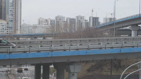 Industrial urban view from train window. Bridges and highways at interchange Vídeos de archivo 134133714