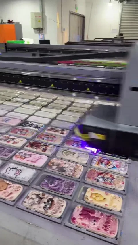 Industrial UV printer printing patterns on smartphone cases in Shenzhen. Video stock 328682699