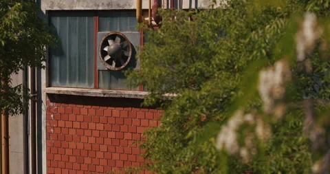 Industrial Ventilation Fan Behind Trees 動画素材 335347424