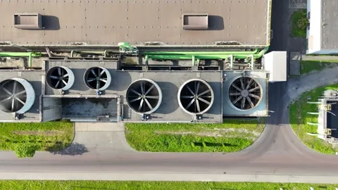 Industrial ventilation system with large fans and ducts visible on the roof of a Видео 335873851