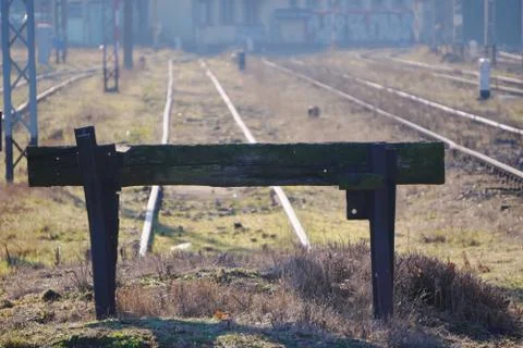 Industrial view of dead end for the train at the old station, black wooden fe Stock Photos