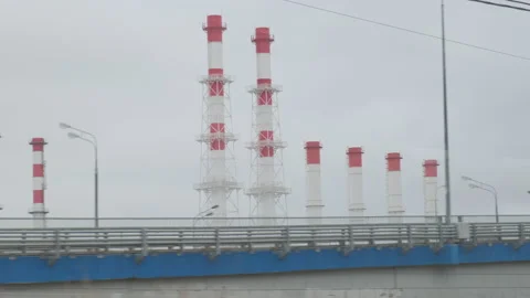 Industrial view from train window. Pipes of the thermal power plant. Pollution Stock Footage 134018481