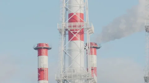 Industrial view from train window. Pipes of the thermal power plant. Pollution Stockbeeldmateriaal 134131399