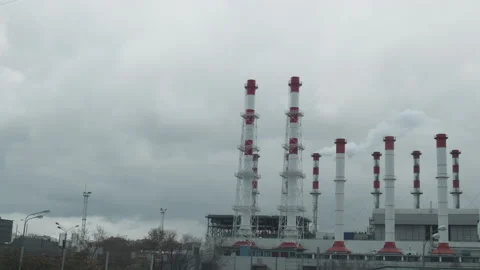 Industrial view from train window. Pipes of the thermal power plant. Pollution Видео 148787937