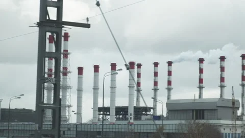 Industrial view from train window. Pipes of the thermal power plant. Pollution Stock-Footage 154118447