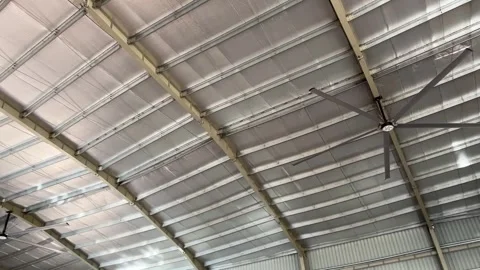 Industrial warehouse ceiling with thermal insulation and large circulation fans Видео 329854931