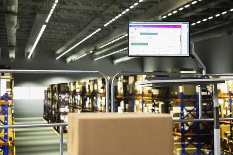 Industrial warehouse with empty platform and computer monitor Stockfoto's