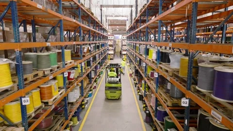 Industrial Warehouse with Forklift Transporting Cable Spools for Automotive Stock Footage 334665870