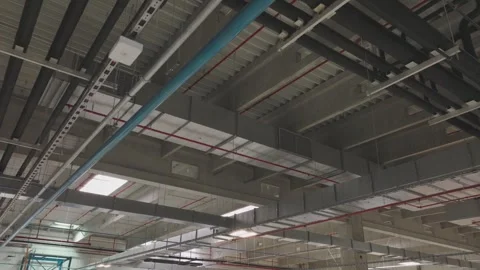 Industrial warehouse interior ceiling with ventilation ductwork and electri.. Stock Footage 337482035