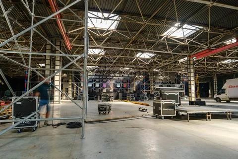 Industrial Warehouse Stage Setup With Scaffolding, Lighting and Equipment Stock Photos