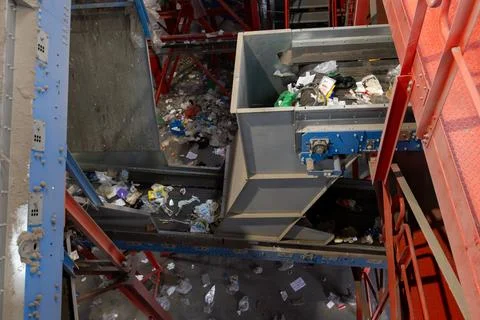 Industrial waste sorting conveyor system with mixed garbage and plastic in Photos