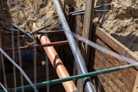 Industrial water pipe burst causing high pressure leak in an open construct.. Stock Photos